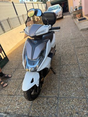 a scooter that is parked on the side of the road