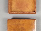 two small wooden boxes sitting on top of a white surface