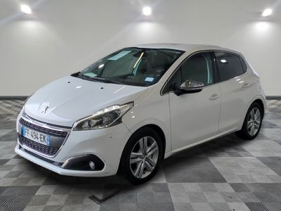 the small white car is parked in a large room