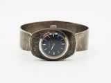 an image of a wrist watch with a blue face on a silver band