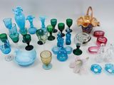 many different colored glass items on a white surface