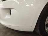 a close up of a car ' s front bumper with a hole in it