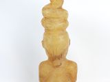 a small statue of a man sitting on a stool