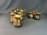three pieces of silverware are sitting on a gray surface
