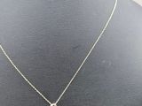 a gold necklace with a snake pendant on a mannequin neck