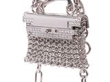 silver chain purse with a chain hanging from it ' s side