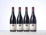 three bottles of wine are lined up on a table