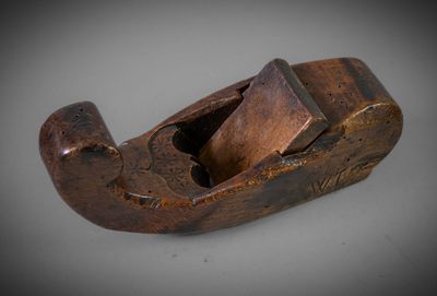 a close up of a wooden plane on a white surface