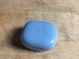a close up of a blue pill case sitting on a wooden table