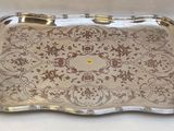an ornate silver tray with handles and handles on a white surface
