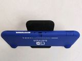 a small blue device that is attached to a white wall