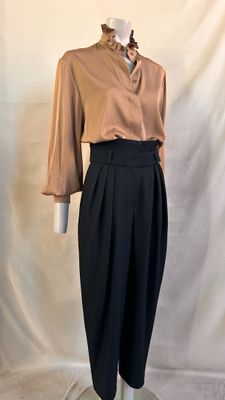 an image of a mannequin wearing a brown shirt and black pants