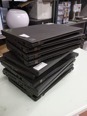 several laptops are stacked on top of each other on a table