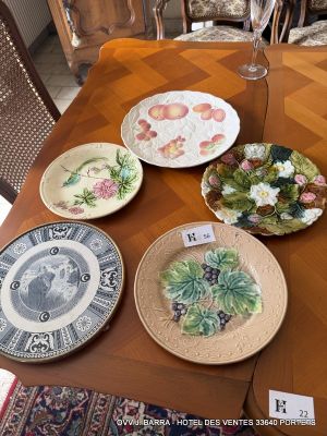 four plates that are sitting on a table with a glass of wine