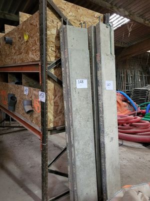 a large pile of pipes in a building with a lot of wood