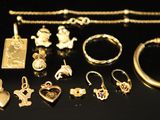 a lot of gold jewelry on a black surface