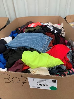 une boîte en carton remplie de vêtements, posée sur une table