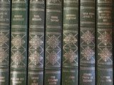 a lot of books that are on a shelf