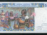 un gros plan d'un billet de banque sur lequel figure l'image d'une femme tenant un bébé dans ses bras