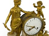a statue of a woman holding a clock and a child