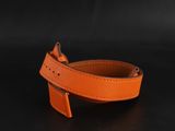 an orange leather belt on a black background