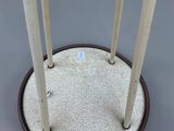 a small table with four white candles on it