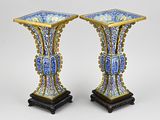 pair of blue and white vases with gold trimmings on stands