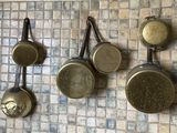 many pots and pans hanging on the wall in the kitchen