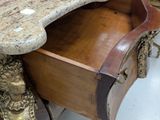 a marble top desk with a drawer underneath it