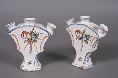 two vases that have been painted with flowers on them