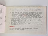 an open book with a game on it sitting on a table