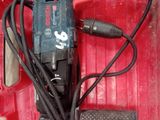 a red box with a drill and other tools in it