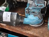 a picture of a corded sander and a bottle of water on a table