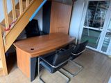 a table and chairs in a room with a staircase