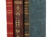 three books that are sitting on a white table
