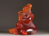 a red gummy bear sitting on top of a white table