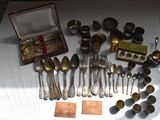a lot of silver spoons and forks on a table