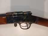 the rifle is sitting on the table ready to be auctioned