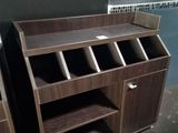 a desk with a book shelf and a cabinet in the corner