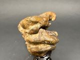 a close up of a sculpture of a hand holding a rock