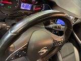 a steering wheel and dashboard of a car in a showroom
