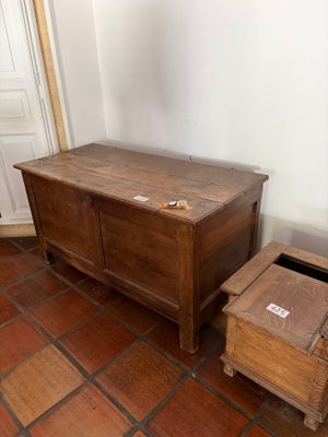 a small wooden chest next to a small wooden box on the floor