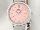 a pink watch with roman numerals on the face