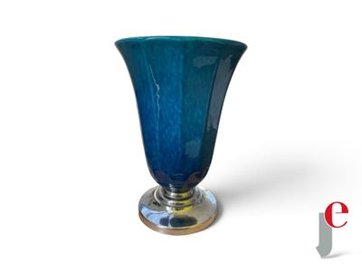 un vase en verre bleu avec un socle en argent sur fond blanc