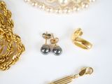 a lot of gold and silver jewelry on a white surface
