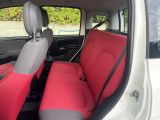 two red seats in the back of a white car
