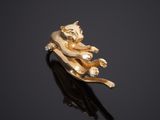 a close up of a gold ring with a cat on it