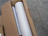 a roll of white paper in a box on the ground