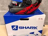 a shark helmet on top of a box with other items