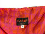 an orange and pink dress with a black label on it